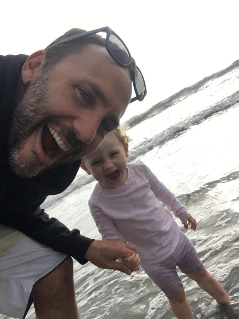 Mark Odlum with his daughter on the beach
