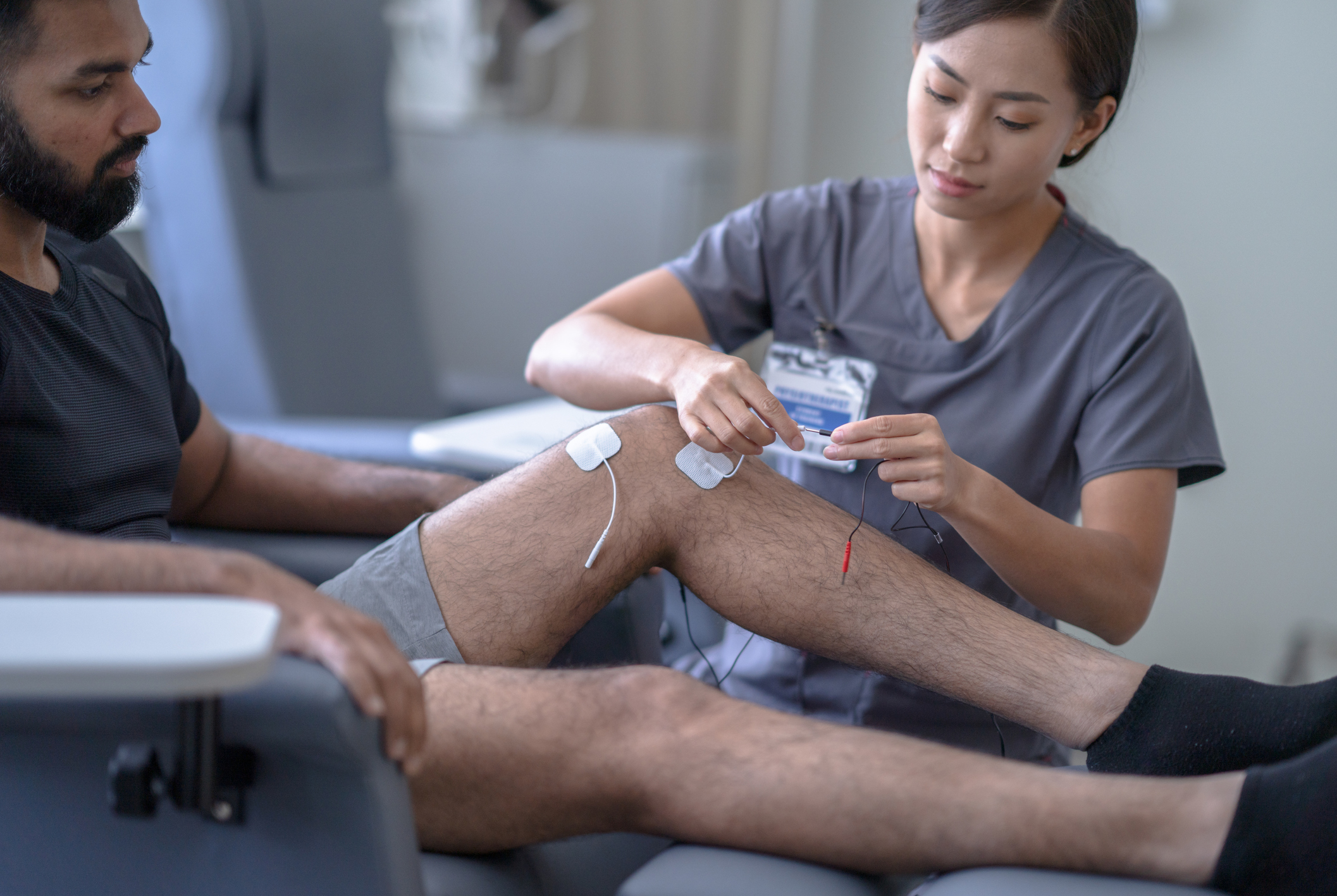 Physical Therapist Hooking Up A TENS Machine