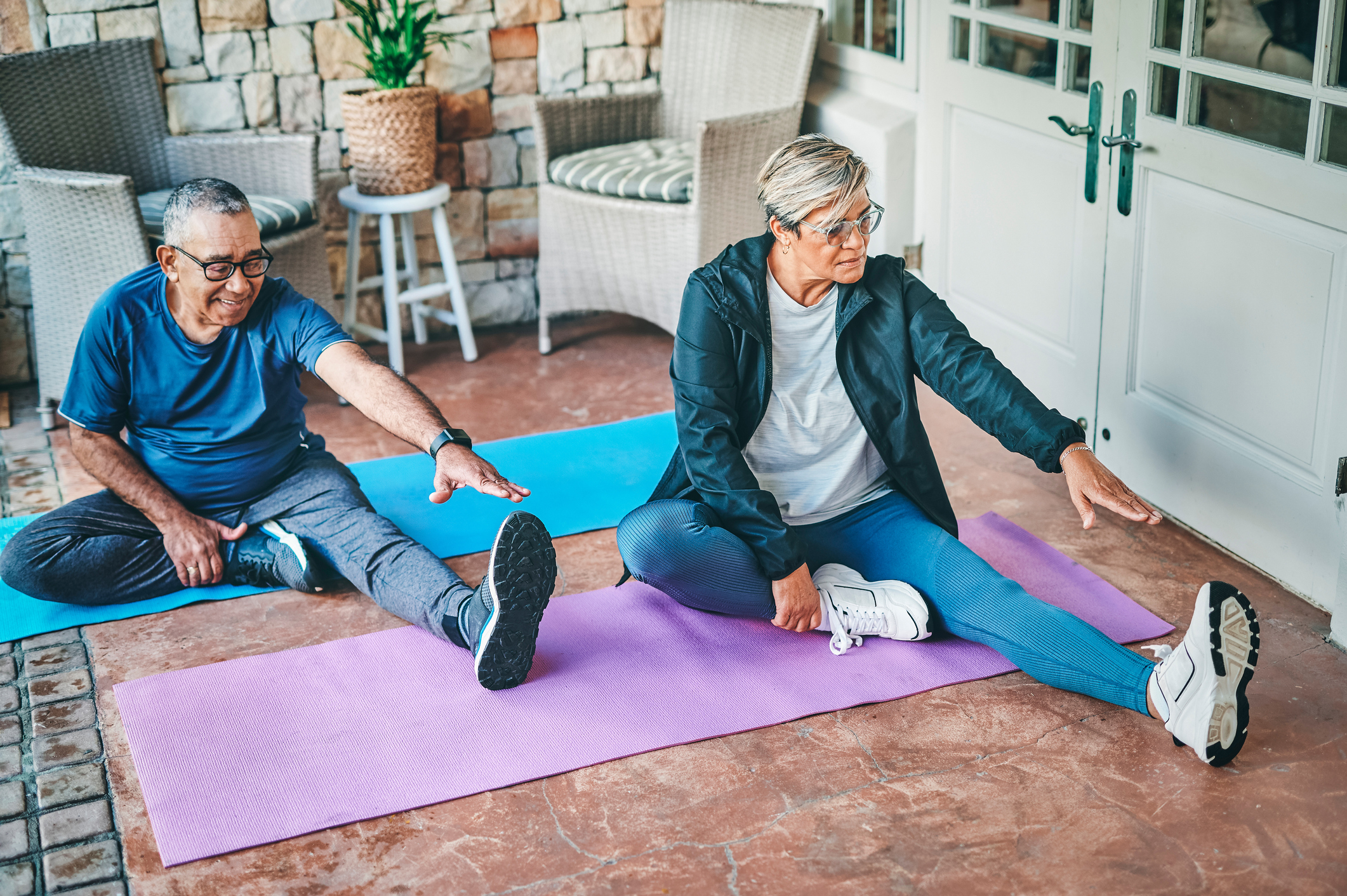 Full length shot of a senior couple bonding together while stretching before doing yoga outside